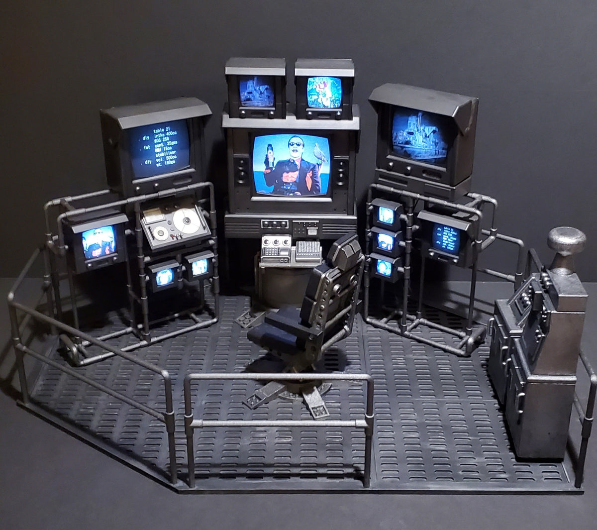 Detailed 3D-printed Batman 1989 Batcave diorama with monitors, control panels, and a central command chair