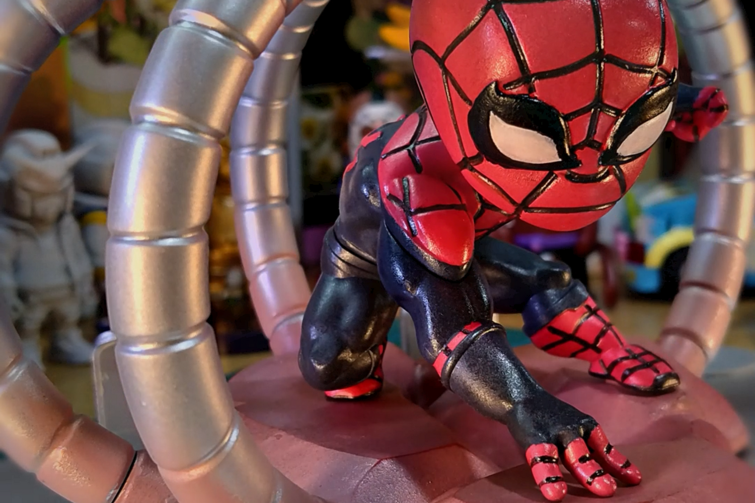 Custom resin 3D printed and hand-painted Spider-Man figure posed among metallic tentacles.